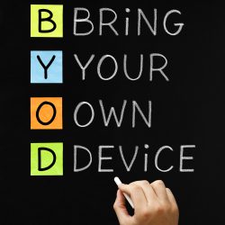 Hand writing Bring Your Own Device with white chalk on blackboard.